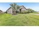 Landscaped front yard and green lawn enhance the curb appeal of this home at 4235 Prima Lago Dr, Lakeland, FL 33810