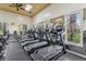 A view inside of the gym featuring modern treadmills, wall mirrors, and abundant natural light at 4235 Prima Lago Dr, Lakeland, FL 33810