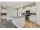 Bright kitchen with center island and stainless steel appliances. Granite countertops and tile floors throughout at 4235 Prima Lago Dr, Lakeland, FL 33810