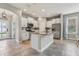 Modern kitchen with stainless steel appliances, white cabinets, and a center island with granite countertops at 4235 Prima Lago Dr, Lakeland, FL 33810