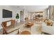 Open living room with modern furnishings, a large TV, and seamless flow into dining and kitchen areas at 4235 Prima Lago Dr, Lakeland, FL 33810
