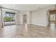 Expansive living room featuring tile flooring and sliding glass doors to a patio at 4235 Prima Lago Dr, Lakeland, FL 33810