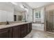 Main bathroom boasts a dual vanity, soaking tub, shower, and stylish fixtures at 4235 Prima Lago Dr, Lakeland, FL 33810