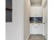 Mudroom with navy tile backsplash, granite countertops, and white cabinets at 4235 Prima Lago Dr, Lakeland, FL 33810
