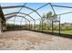 Expansive brick-paved screened patio surrounded by lush landscaping, providing an ideal space for relaxation at 4235 Prima Lago Dr, Lakeland, FL 33810