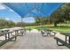 Outdoor picnic area featuring multiple tables and seating under a blue sunshade at 4235 Prima Lago Dr, Lakeland, FL 33810