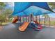 Colorful community playground featuring slides, climbing structures, and a protective sunshade at 4235 Prima Lago Dr, Lakeland, FL 33810