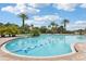 A community pool with marked lap lanes and lush landscaping around it, perfect for swimming at 4235 Prima Lago Dr, Lakeland, FL 33810
