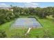 Aerial view of well-maintained tennis and basketball courts surrounded by lush greenery at 4235 Prima Lago Dr, Lakeland, FL 33810