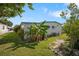 Backyard view showcases lush greenery, banana plants, and a well-maintained lawn at 932 Cassandra Ln, Lakeland, FL 33809