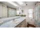 Bathroom features a white sink with cabinets, large mirror and nautical themed shower curtain at 932 Cassandra Ln, Lakeland, FL 33809