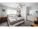 Cozy bedroom with a queen bed, soft carpet, ceiling fan and dresser providing ample storage at 932 Cassandra Ln, Lakeland, FL 33809