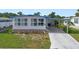 Charming single-story home with a well-kept lawn, long driveway, and car port at 932 Cassandra Ln, Lakeland, FL 33809