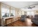 Comfortable living room featuring hardwood floors, large windows, and a ceiling fan, providing a relaxing and inviting atmosphere at 932 Cassandra Ln, Lakeland, FL 33809