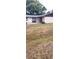 Modest single story home with a mix of siding and a well manicured green lawn in the front of the property at 2505 W Parker St, Lakeland, FL 33815