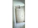 Hallway featuring tile flooring, neutral paint, and decorative lighting at 2505 W Parker St, Lakeland, FL 33815