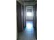 Hallway featuring tile flooring, dark trim doors, and natural lighting at 2505 W Parker St, Lakeland, FL 33815