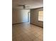 Spacious living room featuring neutral wall colors, tile flooring, and a bright window for natural light at 2505 W Parker St, Lakeland, FL 33815