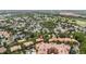 Community aerial view showcasing lush landscaping, mature trees, and neighboring golf course at 504 Mirasol Cir # 102, Kissimmee, FL 34747