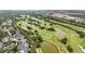 An aerial view showcasing a lush golf course community with ponds and scenic landscaping at 504 Mirasol Cir # 102, Kissimmee, FL 34747