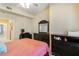 Bedroom with a dark wood dresser and desk and a glimpse of other rooms at 504 Mirasol Cir # 102, Kissimmee, FL 34747