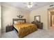 Comfortable bedroom boasts a ceiling fan, carpet flooring, and lots of natural light at 504 Mirasol Cir # 102, Kissimmee, FL 34747