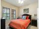 Bright bedroom with a ceiling fan, large window, and a glimpse of outdoor greenery at 504 Mirasol Cir # 102, Kissimmee, FL 34747