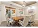 A conference room with a wooden table and white leather office chairs at 504 Mirasol Cir # 102, Kissimmee, FL 34747