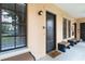 Inviting condo entrance featuring a welcome mat and charming benches for added curb appeal at 504 Mirasol Cir # 102, Kissimmee, FL 34747
