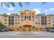A grand building exterior with a water feature, arched entryway, and balconies at 504 Mirasol Cir # 102, Kissimmee, FL 34747