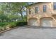 Attached two-car garage with convenient driveway parking and landscaping at 504 Mirasol Cir # 102, Kissimmee, FL 34747