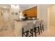 Kitchen with bar seating featuring sleek countertops and wood cabinets at 504 Mirasol Cir # 102, Kissimmee, FL 34747