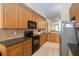 Bright kitchen featuring modern appliances, wood cabinetry, and ample counter space at 504 Mirasol Cir # 102, Kissimmee, FL 34747