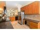 Well-equipped kitchen with stainless steel appliances and abundant wood cabinets at 504 Mirasol Cir # 102, Kissimmee, FL 34747