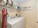 Functional laundry room includes a washer, dryer, and shelf space at 504 Mirasol Cir # 102, Kissimmee, FL 34747