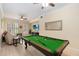 Bright living space features a pool table, fan, and access to the outdoor space at 504 Mirasol Cir # 102, Kissimmee, FL 34747
