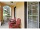 Relaxing screened-in porch with two Adirondack chairs that create an inviting outdoor space at 504 Mirasol Cir # 102, Kissimmee, FL 34747