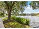 Scenic view of a tranquil pond with lush greenery and flowering plants along the shoreline at 504 Mirasol Cir # 102, Kissimmee, FL 34747