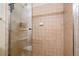 Tiled shower stall with glass doors and showerhead fixture in a bright bathroom at 504 Mirasol Cir # 102, Kissimmee, FL 34747