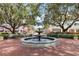 Picturesque town square showcasing a water fountain, surrounded by benches and lush landscaping at 504 Mirasol Cir # 102, Kissimmee, FL 34747