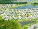 Aerial view of homes near a community lake in the neighborhood at 5934 Shingle Creek Rd, Lakeland, FL 33811