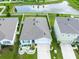 Aerial view of a home featuring manicured landscaping, a driveway, and a pond nearby at 5934 Shingle Creek Rd, Lakeland, FL 33811