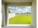 Inviting backyard with a lush green lawn, fenced perimeter, and covered patio area at 5934 Shingle Creek Rd, Lakeland, FL 33811