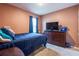 Comfortable bedroom with a full-size bed, dresser, and a mounted TV for entertainment at 5934 Shingle Creek Rd, Lakeland, FL 33811