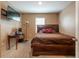 Bedroom with wooden bed frame, side desk and mounted TV at 5934 Shingle Creek Rd, Lakeland, FL 33811
