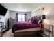 Cozy bedroom featuring a large bed, dresser, and a mounted TV for relaxation at 5934 Shingle Creek Rd, Lakeland, FL 33811