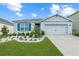 Charming single-story home featuring a well-manicured lawn and bright blue shutters against a beautiful blue sky at 5934 Shingle Creek Rd, Lakeland, FL 33811