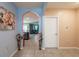 Arched doorway transitions the tile floored hallway to the living area, complemented with elegant decorative vases at 5934 Shingle Creek Rd, Lakeland, FL 33811