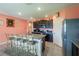 Well-appointed kitchen features granite countertops, stainless steel appliances, and an island with bar stool seating at 5934 Shingle Creek Rd, Lakeland, FL 33811