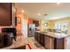 Well-equipped kitchen with stainless steel appliances, dark wood cabinets and an island with a sink at 5934 Shingle Creek Rd, Lakeland, FL 33811